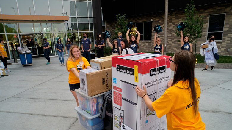 Volunteers assist with students moving into the dorms for the Fall Semester.
