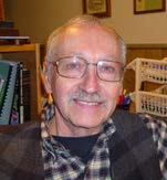 Image of Ed Levert wearing glasses and a black and white checkered button up.