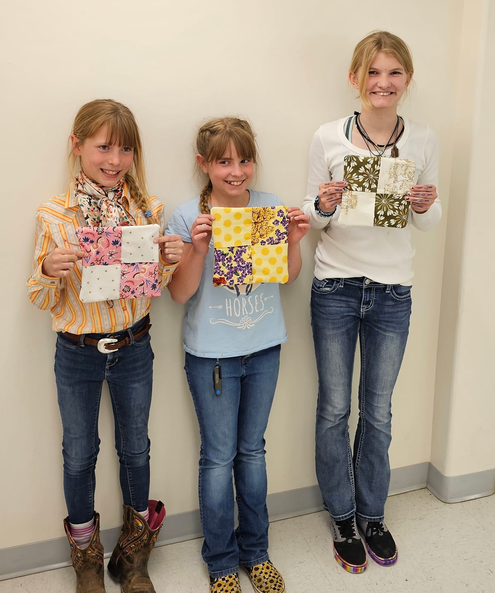 4-Her's proudly holding up the pot holders they made