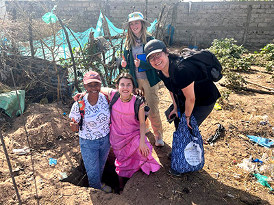 MSU researchers pose at the first hole dug at Ndangane factory site