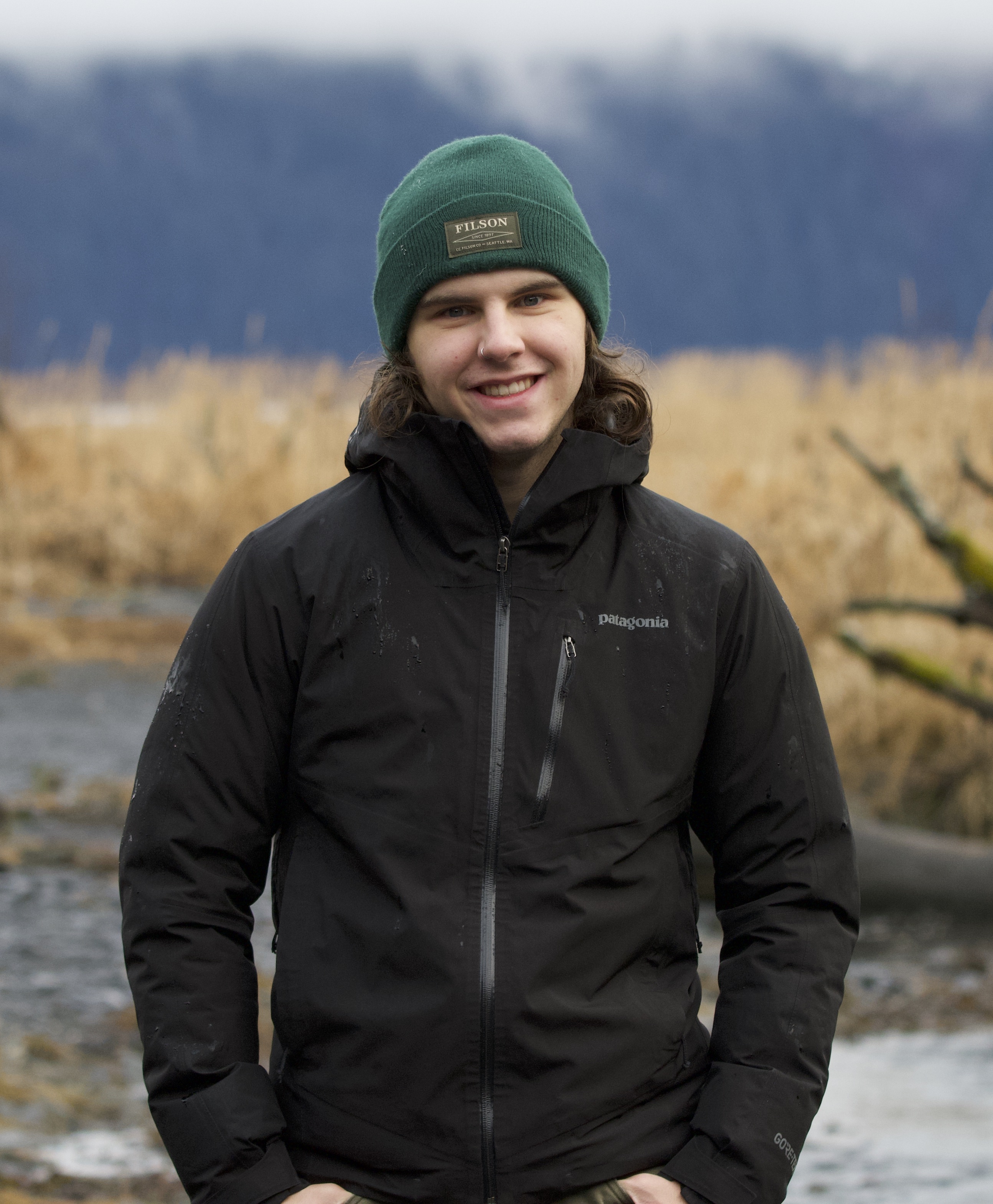 Carter Berg in front of misty mountains