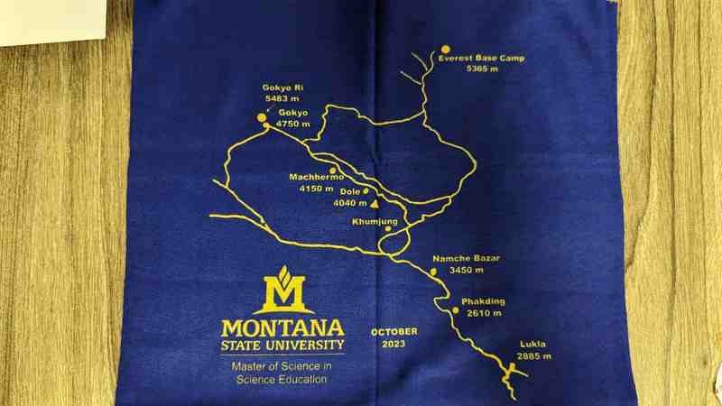 A Montana State University flag that has a printed map outlining the upcoming trip.