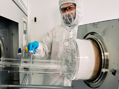 person in PPE working in lab